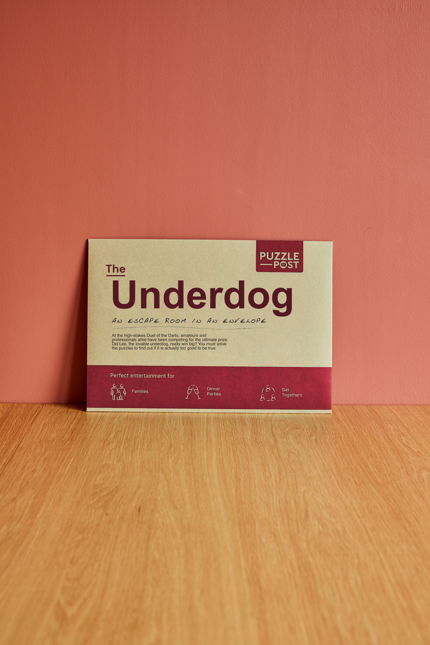 Puzzle Post Escape: The Underdog envelope game—eclectic darts-themed illustration, eco-friendly packaging, escape room adventure for 2–8 players.