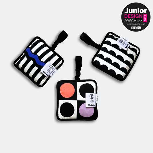 Baby engaging with Etta Loves x Walala Sensory Hanging Square during tummy time