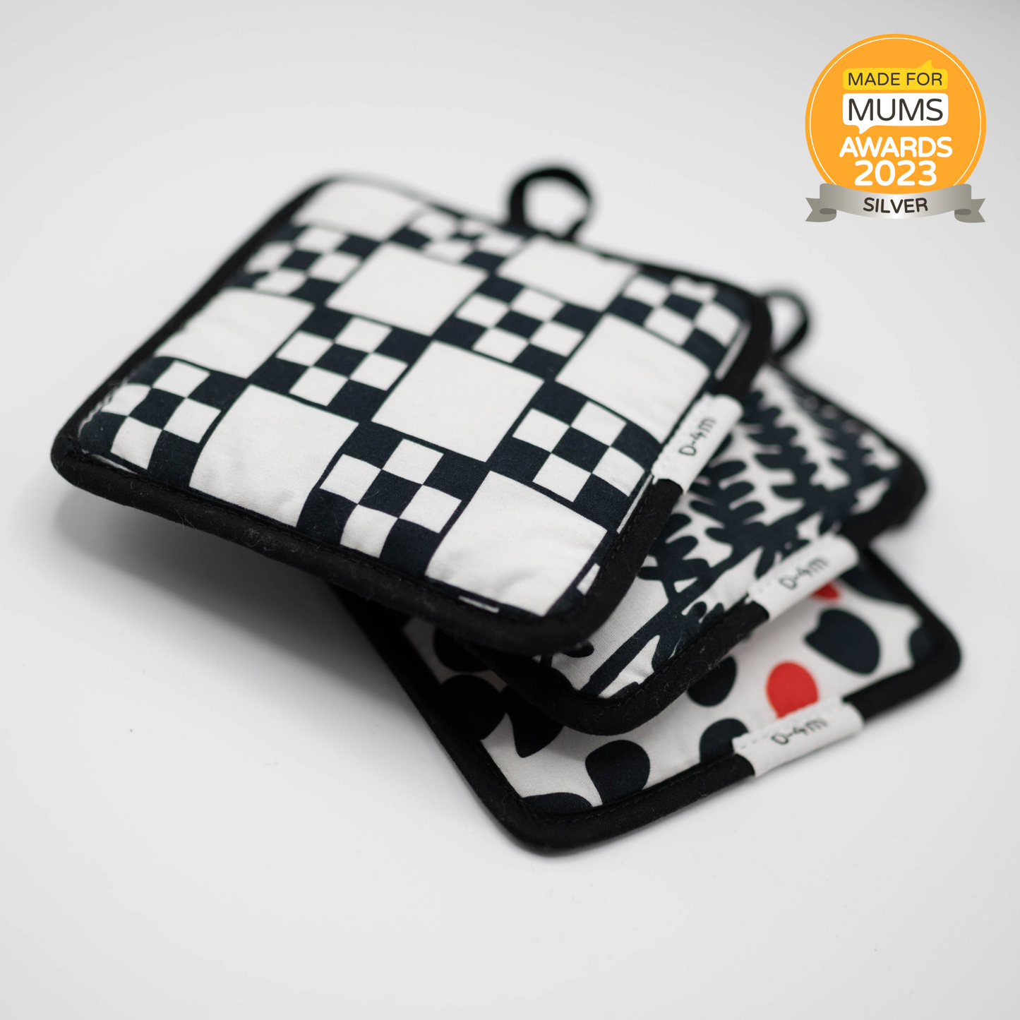 Triple pack of Etta Loves sensory hanging squares in fern/sycamore, chequers/illusion, and dalmatian/mirror designs, approx 13cm, with sensory features and velcro attachments.