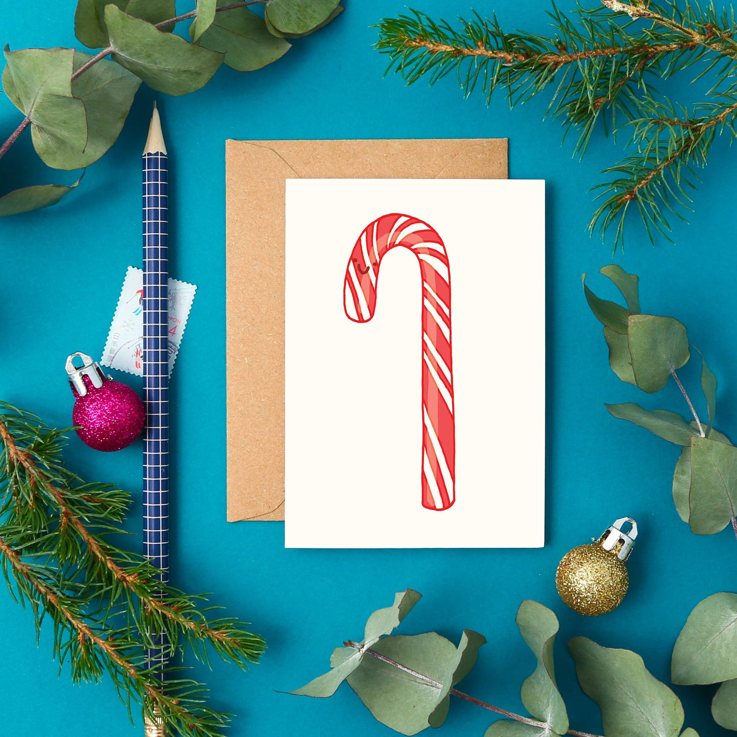 Mini Candy Cane card with red and white stripes, hand-drawn smiling design, UK-made sustainable 300gsm card, A7 size
