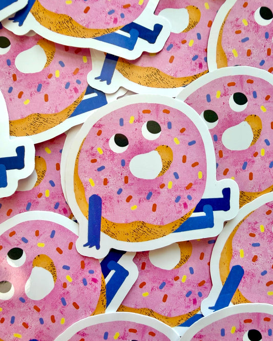 Brighten up your everyday items with this adorable pink doughnut vinyl sticker, beautifully illustrated by Emily Nash