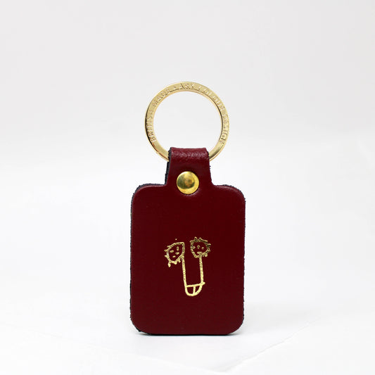 Close-up of the playful leather key fob with a gold keyring attachment