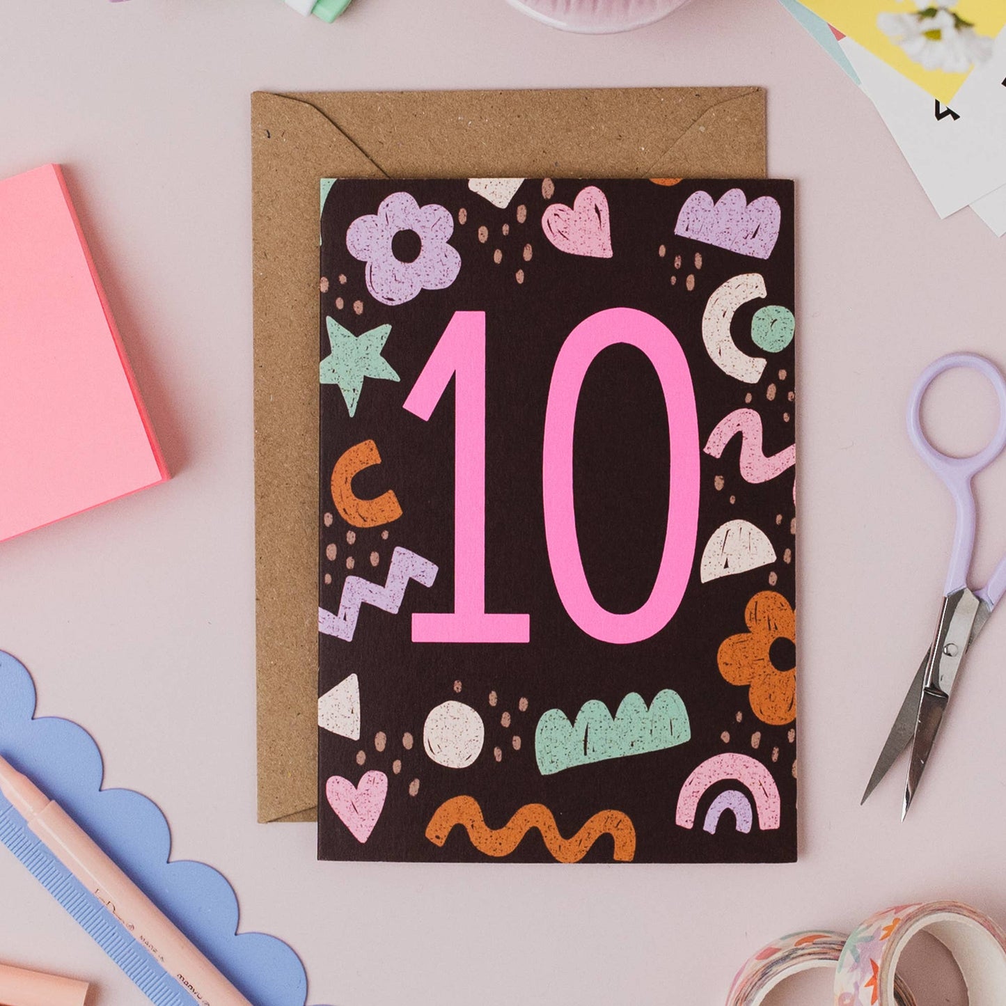 Vibrant neon pink number 10 on birthday card, close-up