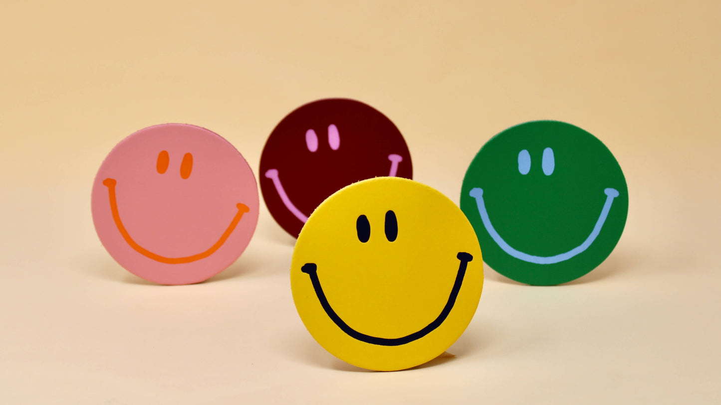 Happy Face Smilie Leather Coasters - Set of 4. Pink, Yellow, Green and Burgundy. Designed and made in the UK.