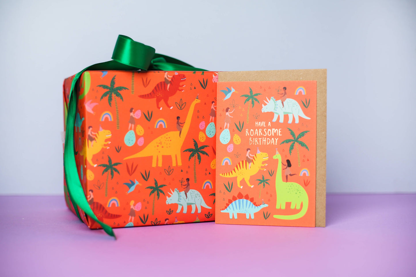 Close-up of eco-friendly dinosaur gift wrap, showing detailed illustration