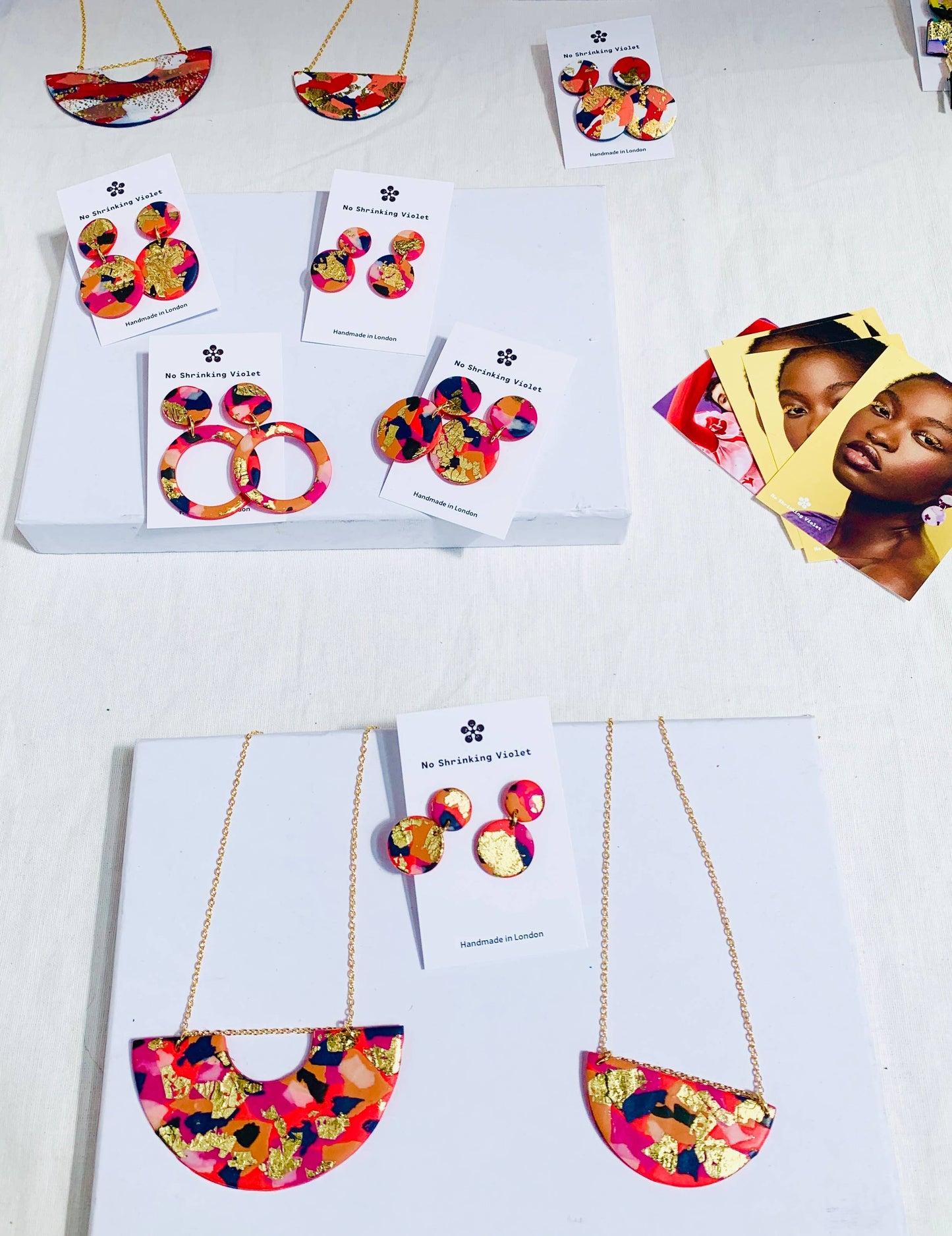 Model wearing Fire & Flood Mini Polymer Clay Earrings, highlighting their size and style when worn.