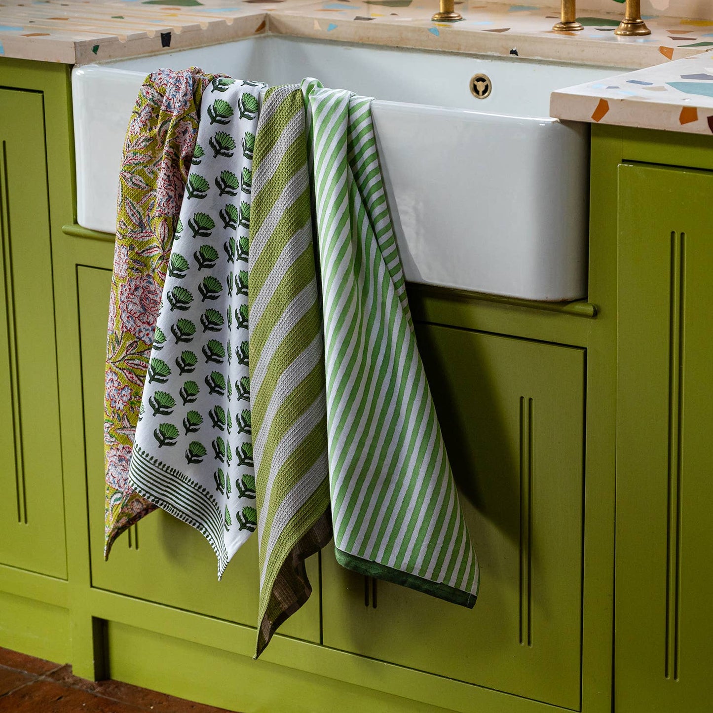 Folded olive stripe tea towel showing waffle texture and loop hook