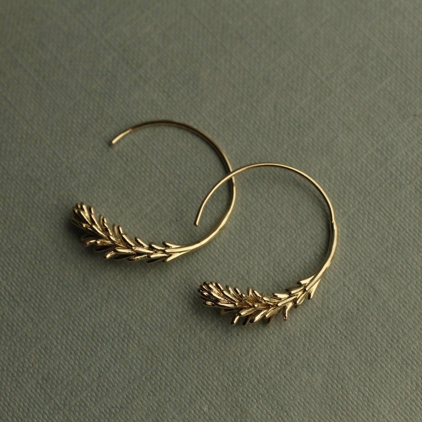 These rosemary leaf hoop earrings are made from plated brass with some amazing detail on the leaves. They feature a detailed botanical sprig of leaves, in a choice of gold. The hoop earrings measure 30mm in diameter and come with butterfly earring backs for a secure fit.
Designed and crafted in the UK.