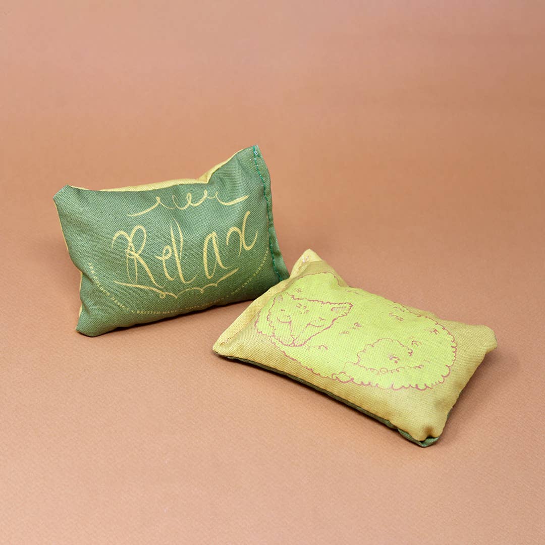 Yellow sleeping cat lavender bag made with organic cotton, illustrated and filled with calming lavender.