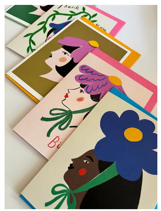 Collection of Blue Flower Lady Greeting Cards, showcasing the hand-illustrated woman with a blue bloom headpiece, alongside other floral designs.