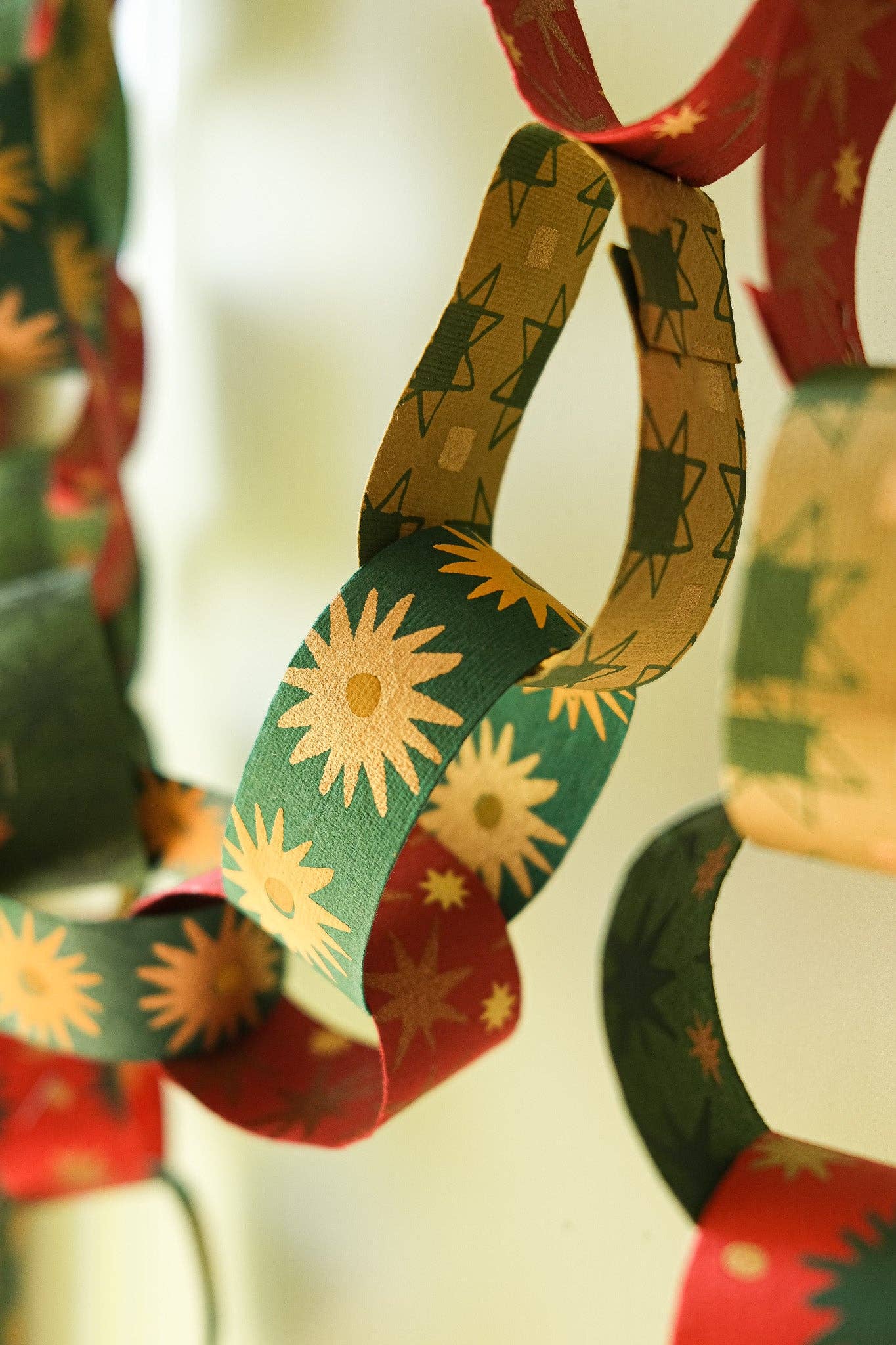 Recycled festive paper chain strips, hand-printed double-sided, eco-friendly decoration kit.