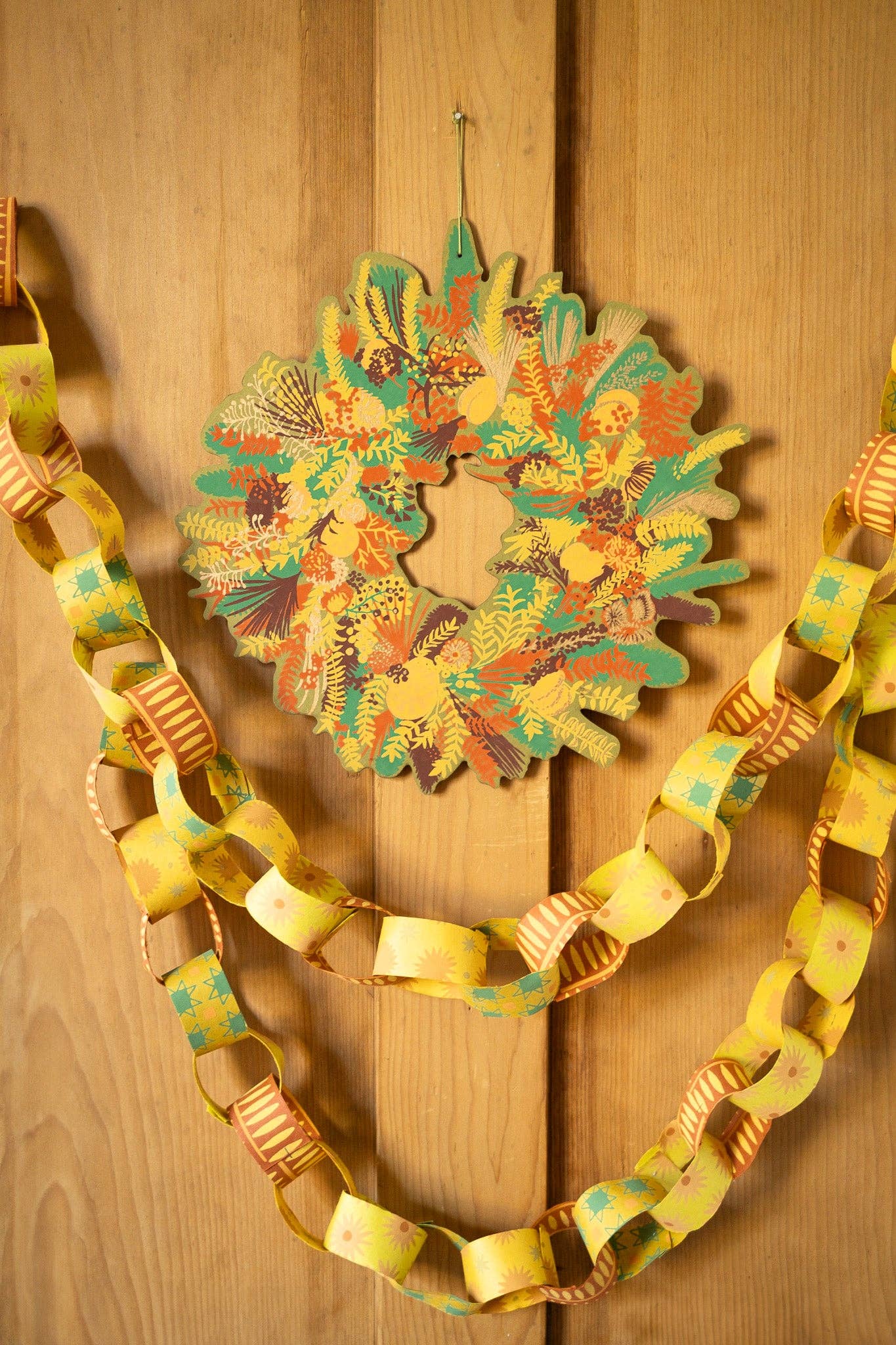 Hand-printed cotton board wreath with winter blooms, sustainable Christmas ornament