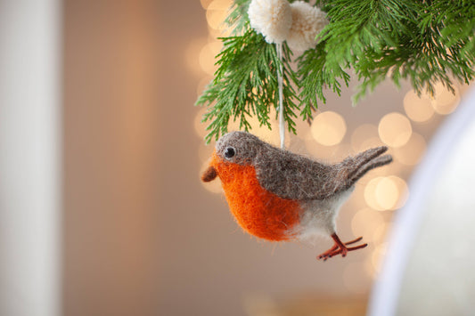 Close-up of a charming handmade Robin Christmas ornament, showcasing needle felting detail and soft wool texture.