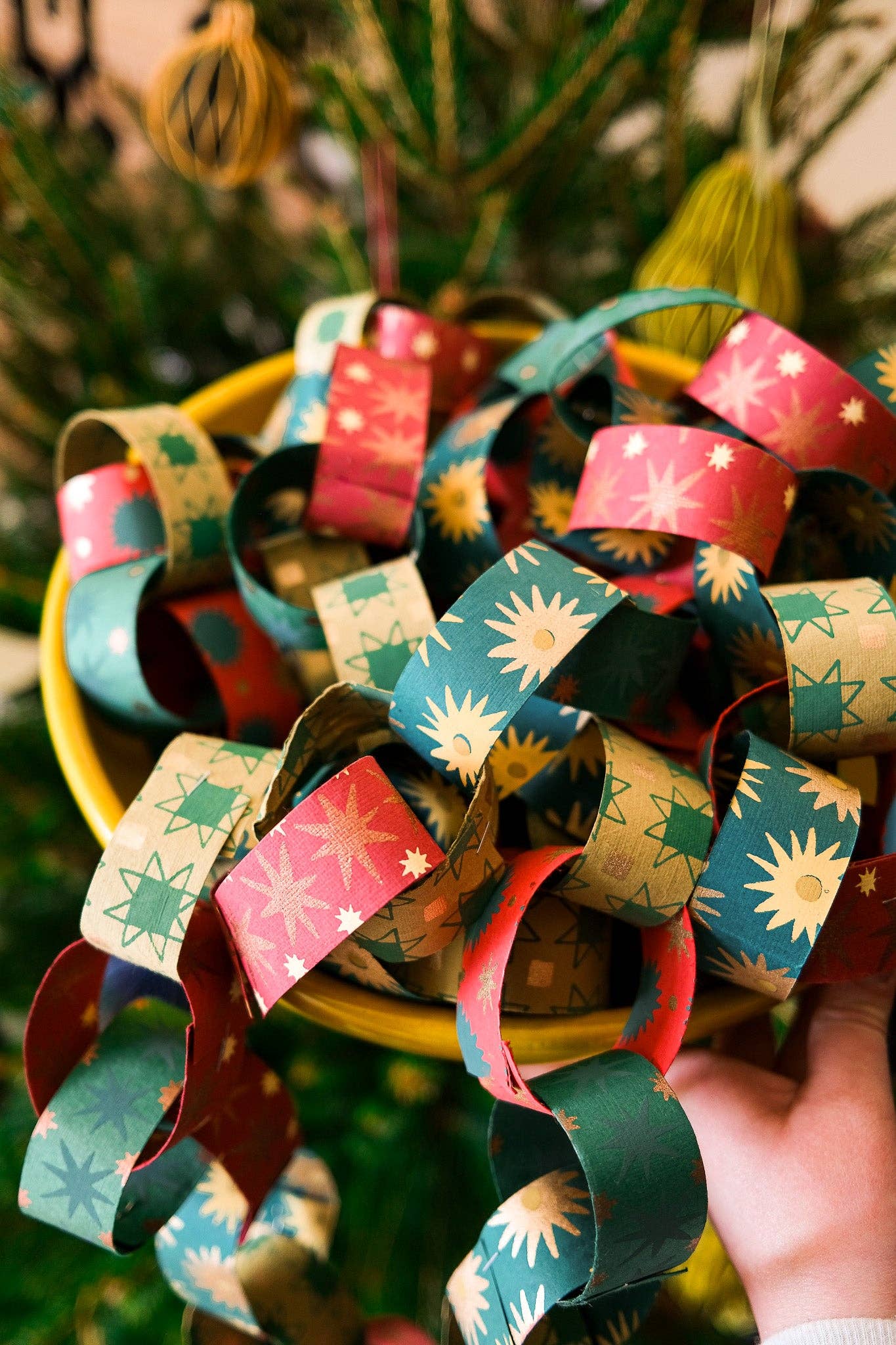 Recycled festive paper chain strips, hand-printed double-sided, eco-friendly decoration kit.