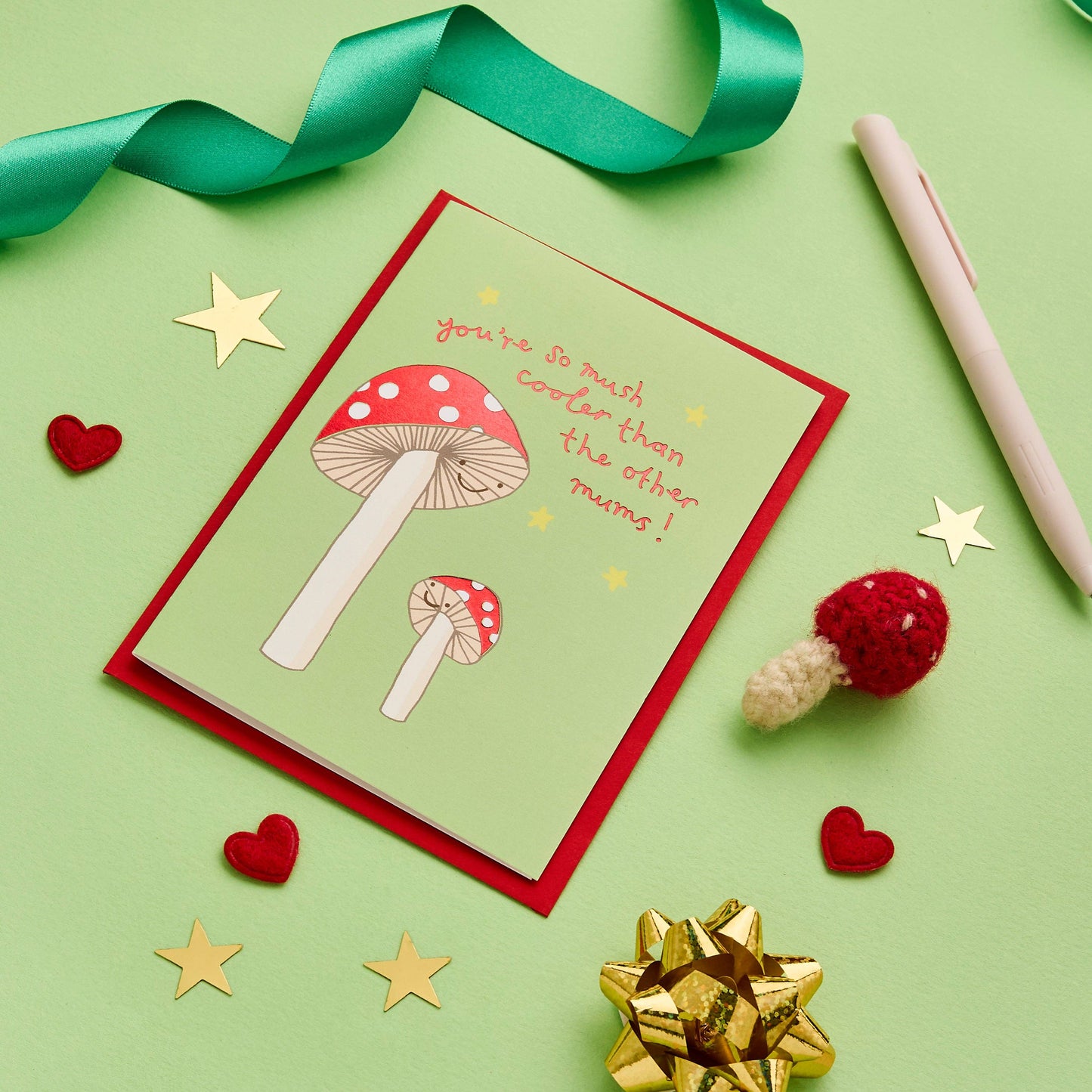 Stunning mum card perfect for a female birthday or Mothers Day message. Beautiful, original hand drawn design featuring a mushroom mum alongside her mini mushroom, painted in striking colours.
Written in a lovely, original hand lettered font and finished with gold foil, the endearing message on the front of this unique greeting card reads "You're so mush cooler than the other mums"