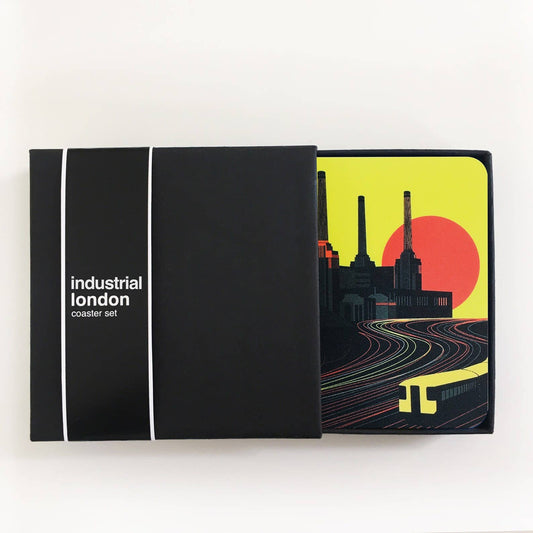 Industrial London Coaster Gift Set. Set of 4 coasters featuring London Landmarks. Battersea, Hackney, Croydon and Brick Lane Gasholders and chimneys. The gritty, not so pretty side of industrial London. Featuring the Battersea Power station, the gasworks at Waddon Marsh Croydon, the chimney of the Old Truman Brewery, and the gas holders by the canal in Hackney, as seen from an overground train. The coasters come in a smart black box, with the words Industrial London Coaster Set in white font.