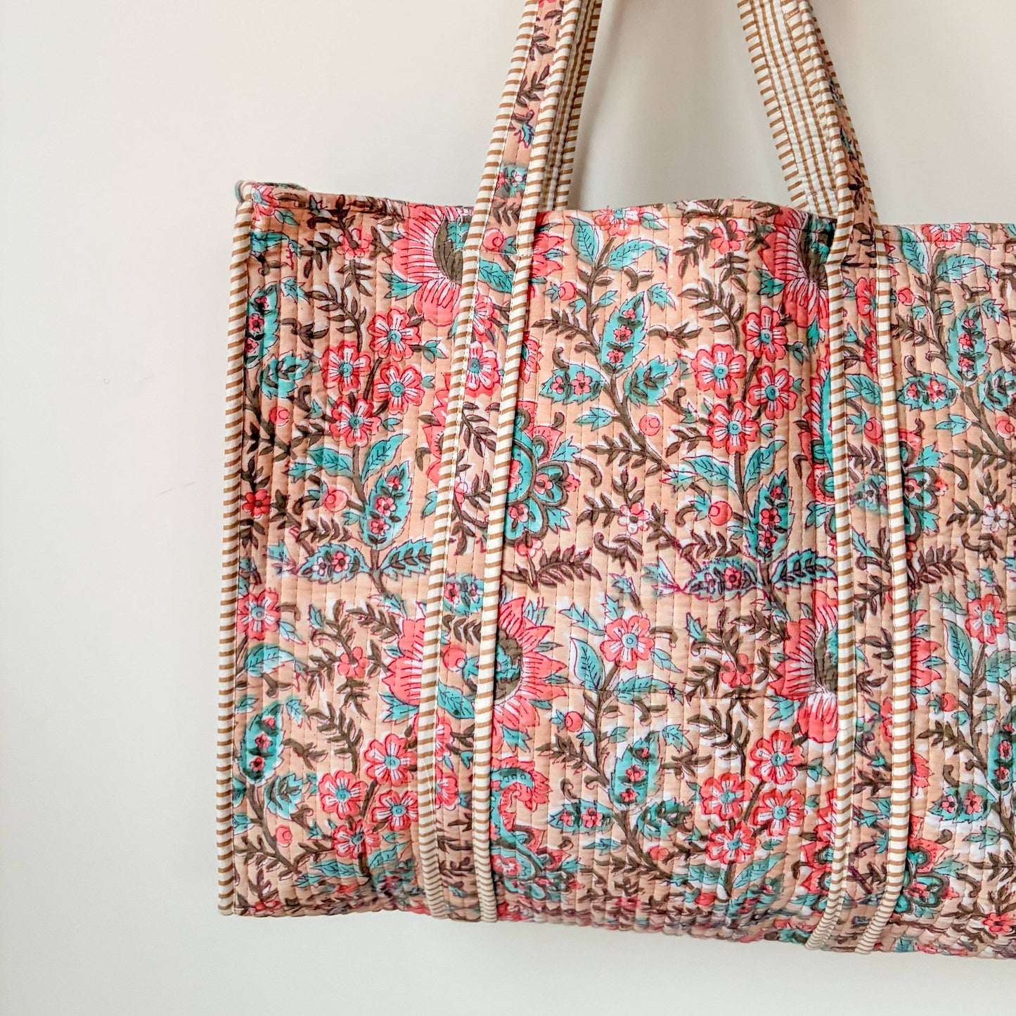 Interior detail of quilted cotton tote bag showing striped lining