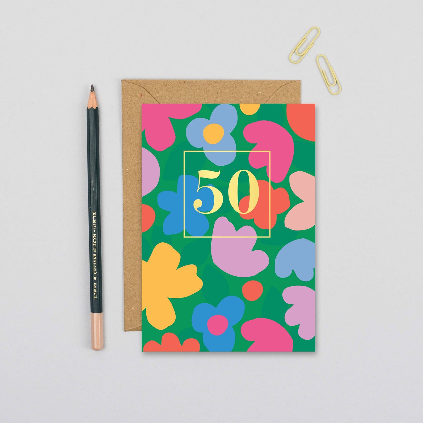 Age 50 Bloom Burst Birthday Card with colourful floral design on a green background, paired with a recycled kraft envelope.