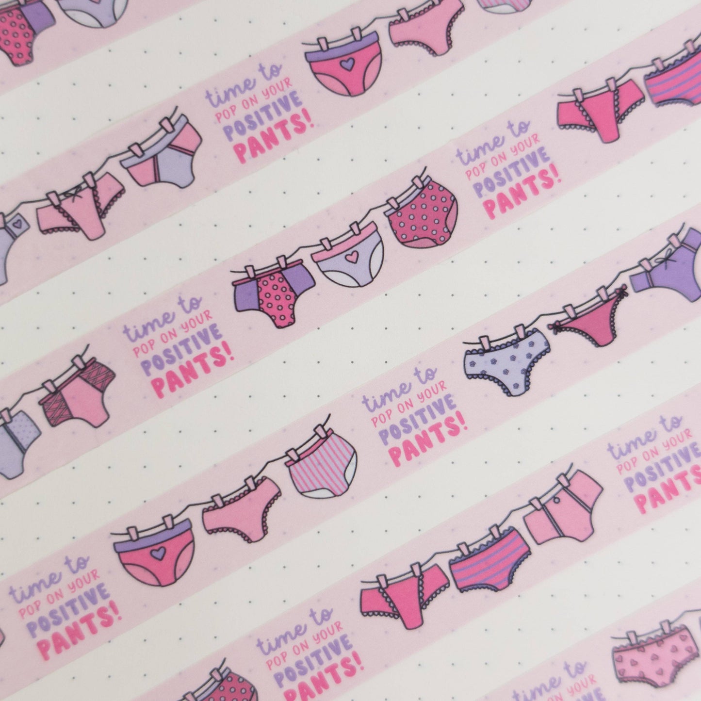 Pink and purple patterned pants washi tape with “pop on your positive pants” message and eco-friendly paper packaging—perfect for uplifting journaling and craft projects.