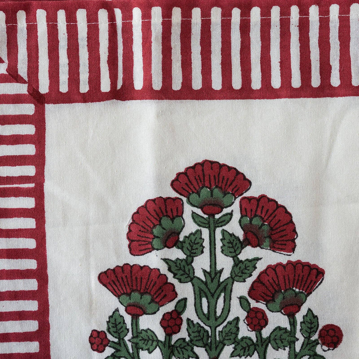 Winterberry cotton napkins styled with simple ceramics and seasonal flowers