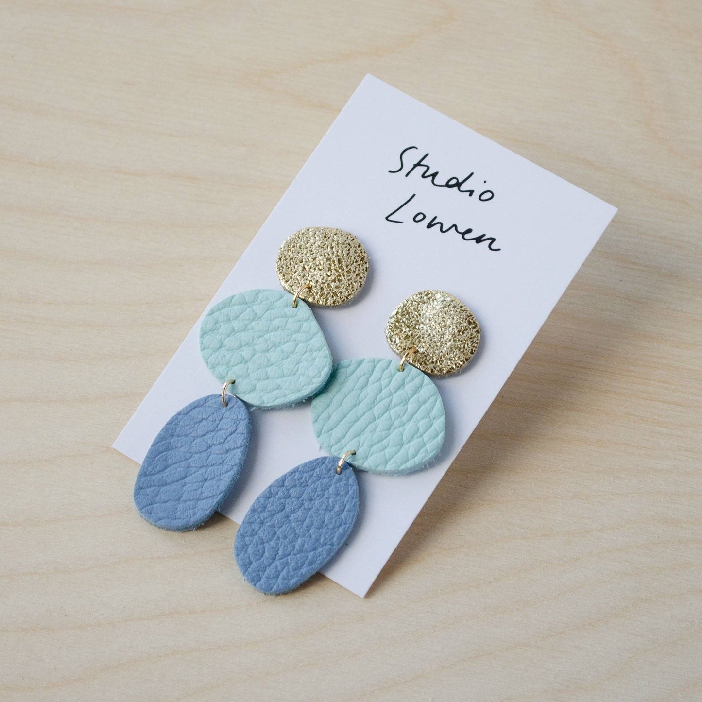 Kensa Coastal Dangle Earrings in Shimmer Gold, Powder Blue, and Seaglass Italian leather offcuts. Lightweight and elegant.