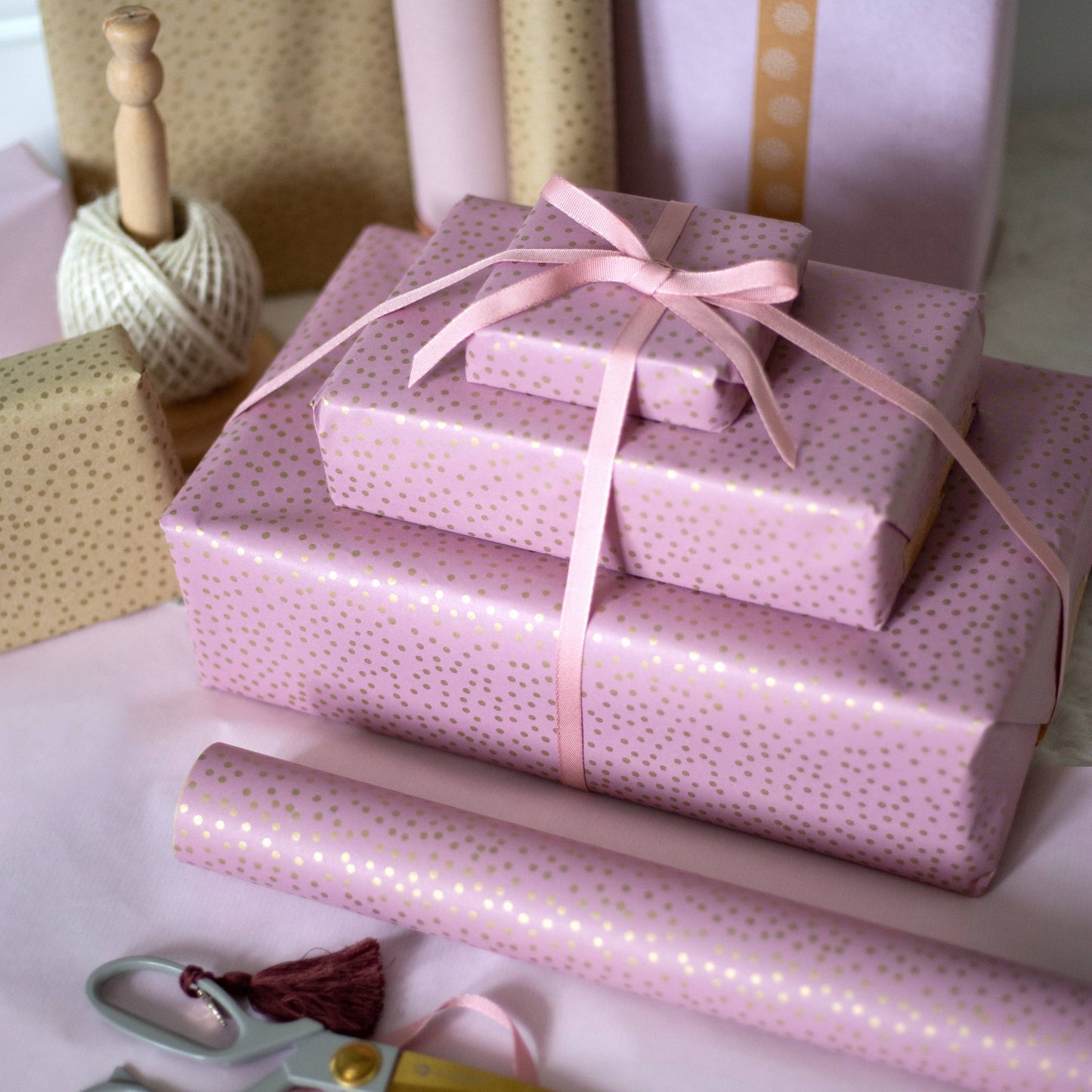 Close up of eco-friendly pink and gold dot recycled gift wrap