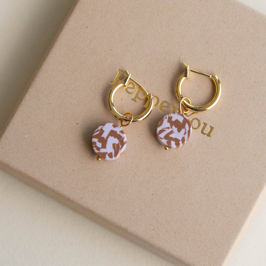 Close-up of Pepper You Bits Circle Clay Hoop Earrings, Chocolate & Lilac, with eco gift box