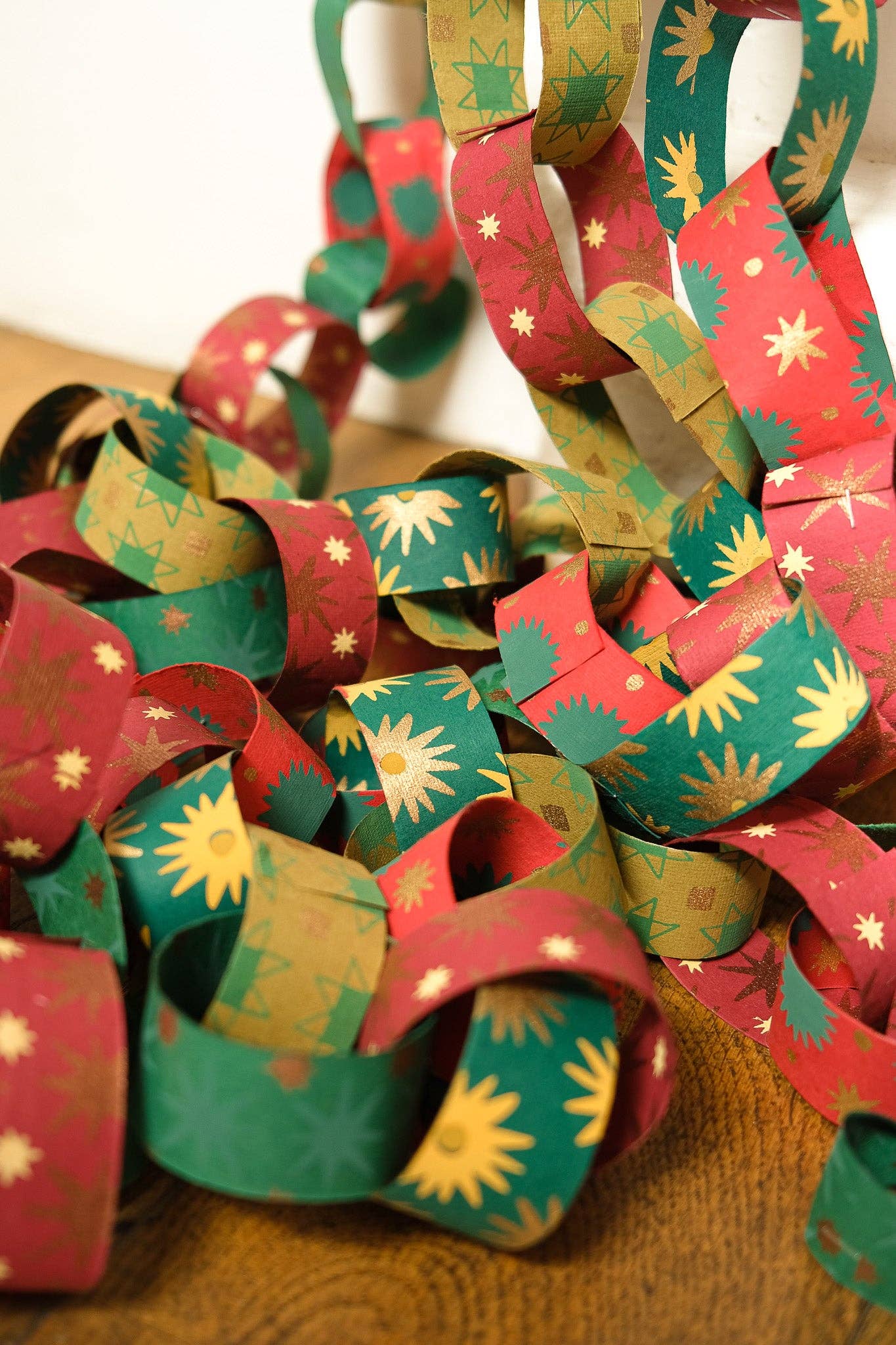 Recycled festive paper chain strips, hand-printed double-sided, eco-friendly decoration kit.