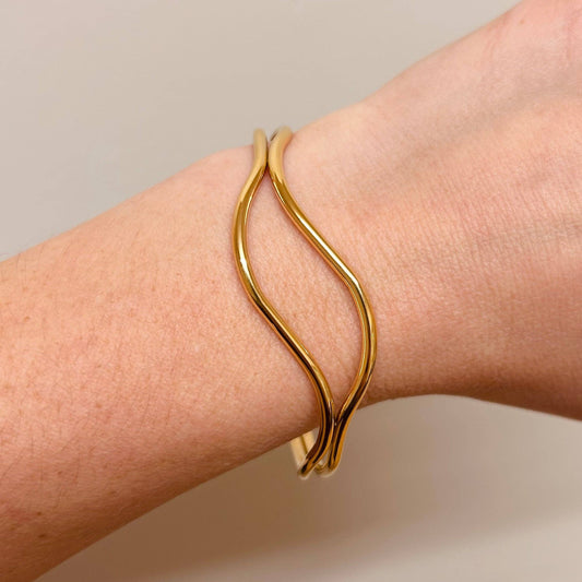 Model wearing 18k gold plated abstract bangle, adjustable design