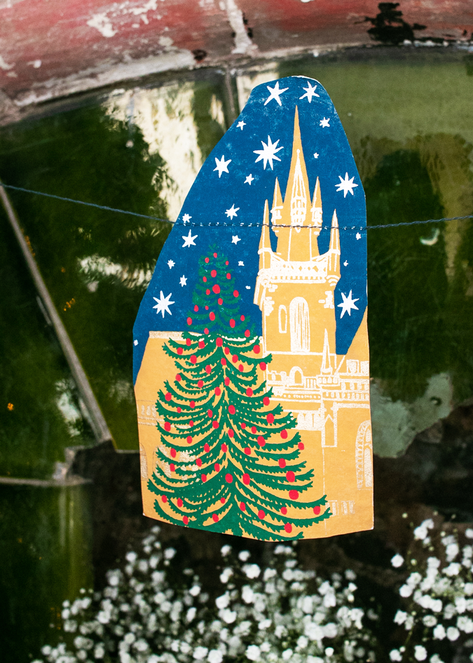 Screen printed Skyline Sewn Garland by East End Press with festive night time skyline images on recycled paper