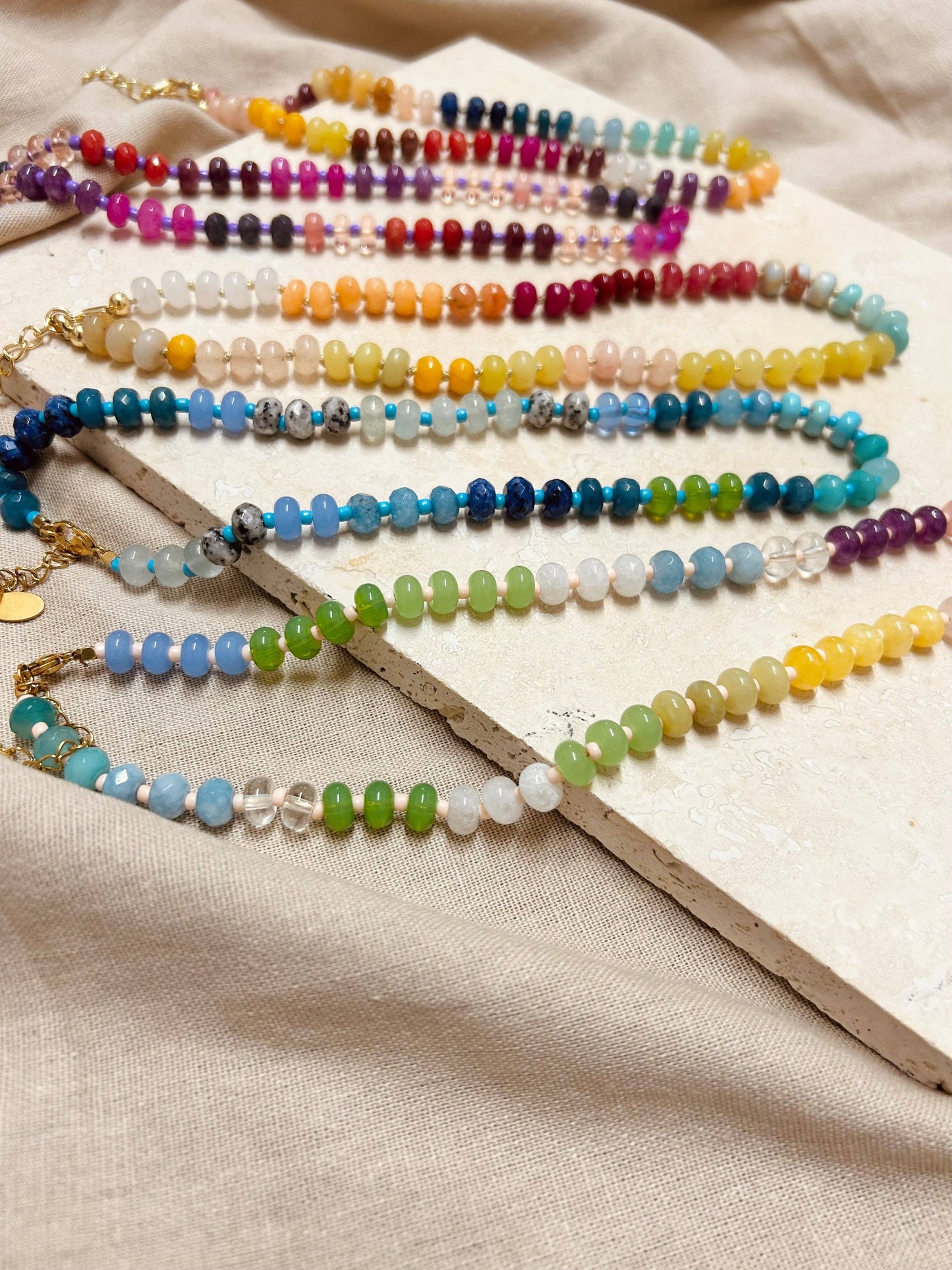 Collection of Little Nell colourful beaded necklaces, including the Ocean style, on display