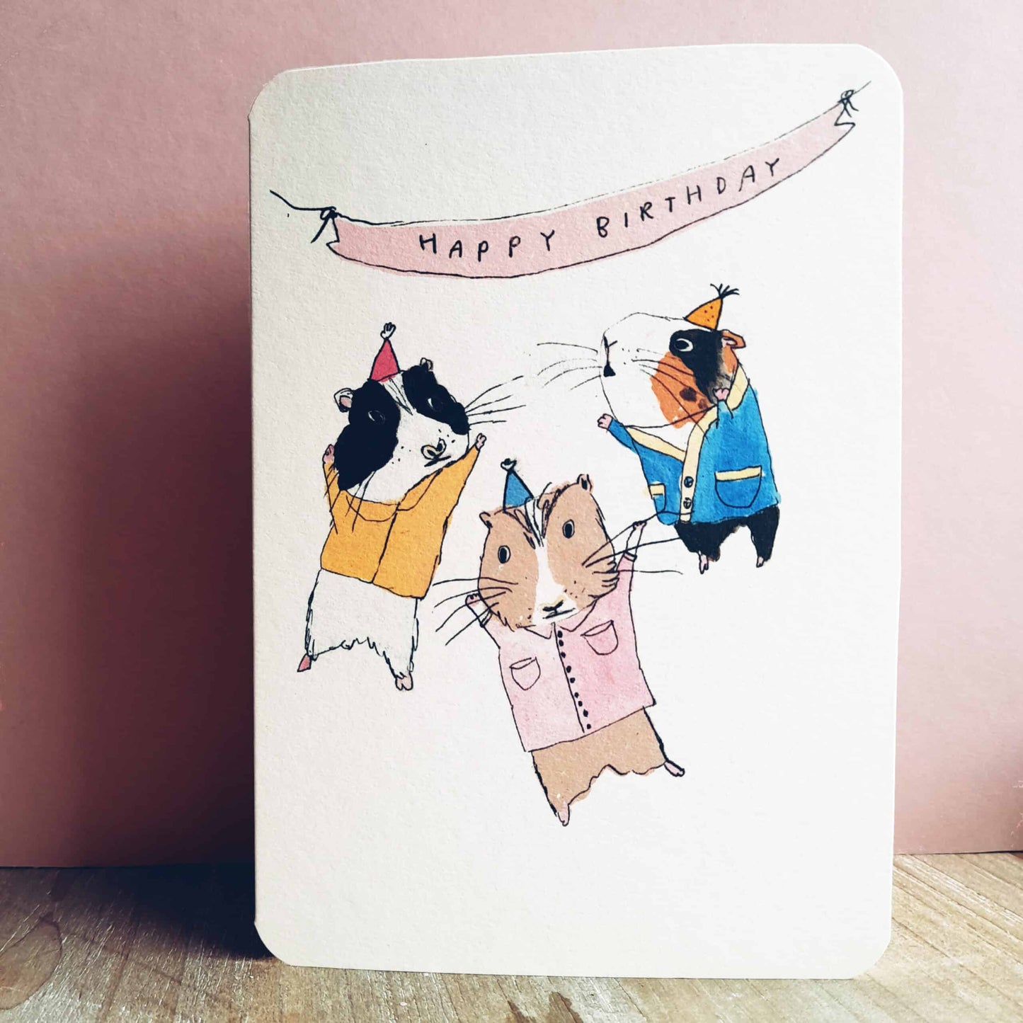 Birthday Guinea Pig Party Card by Laura Skillbeck featuring three guinea pigs in party hats