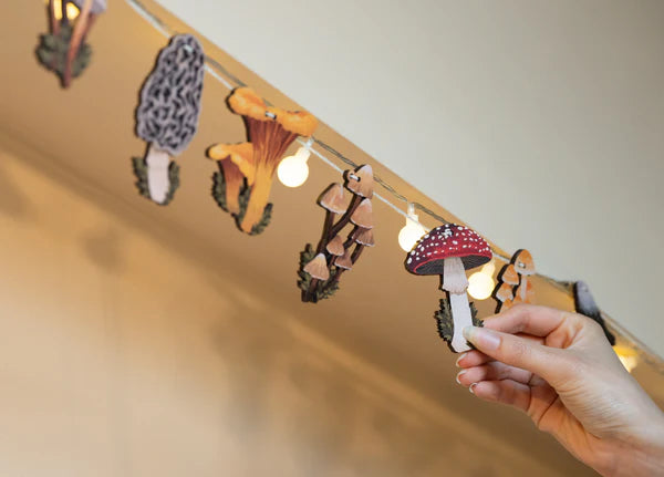 Hand designed Mushrooms of the British Isles garland, perfect for decorating your home or workspace. Perfect for nature lovers or toadstool enthusiasts. Made from sustainably sourced maple wood.
Made in Dapple & Dot's New Forest studio, from the illustration, to the laser cutting, to the printing to the packing.
EACH PRODUCT INCLUDES: 1 x pop out wooden sheet, 2 metres of cotton twine, 1 x labelled kraft envelope as packaging.