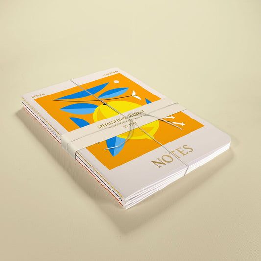 Close-up of Darling Clementine fruit design stitched notebooks with gold foil detail, A5 size, eco-friendly.