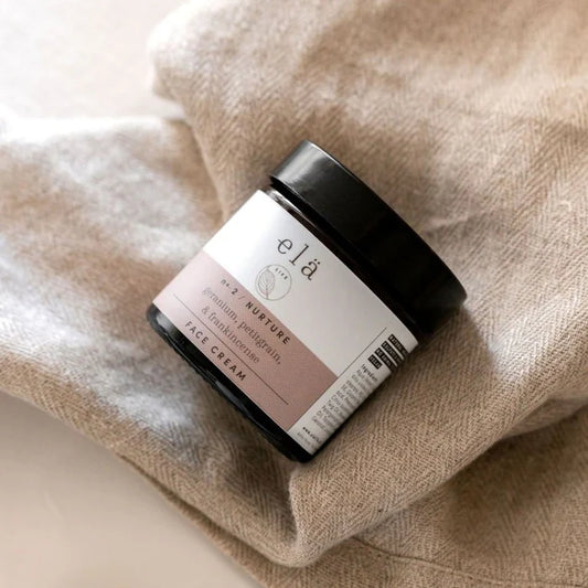 Hand applying Nurture No 2 Face Cream 60ml to skin, showing creamy texture