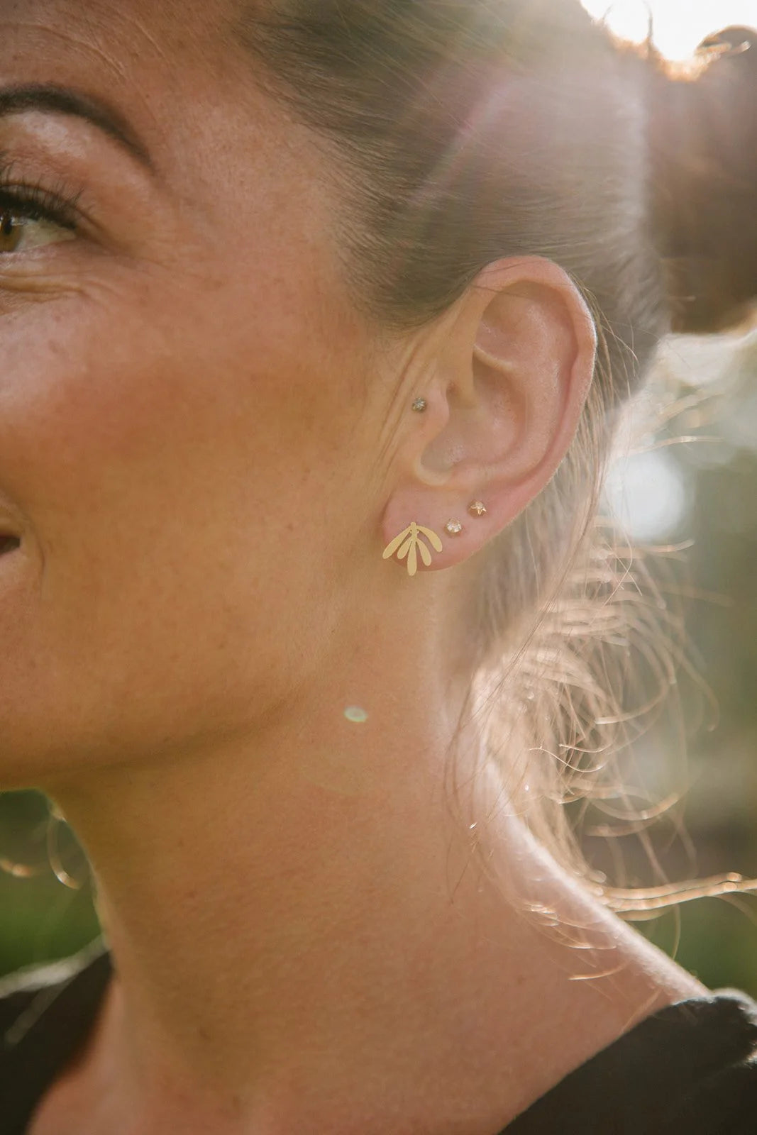 Delicate botanical brass leaf stud earrings from Copper Bee, hypoallergenic stainless steel posts, intricate laser-cut design, lightweight handmade UK jewellery.