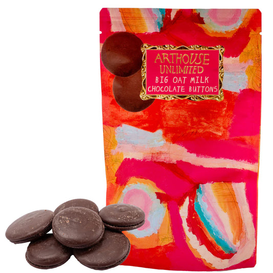 Colorful packaging of Arthouse Unlimited Big Oat Milk Chocolate Buttons with chocolate buttons displayed in front.