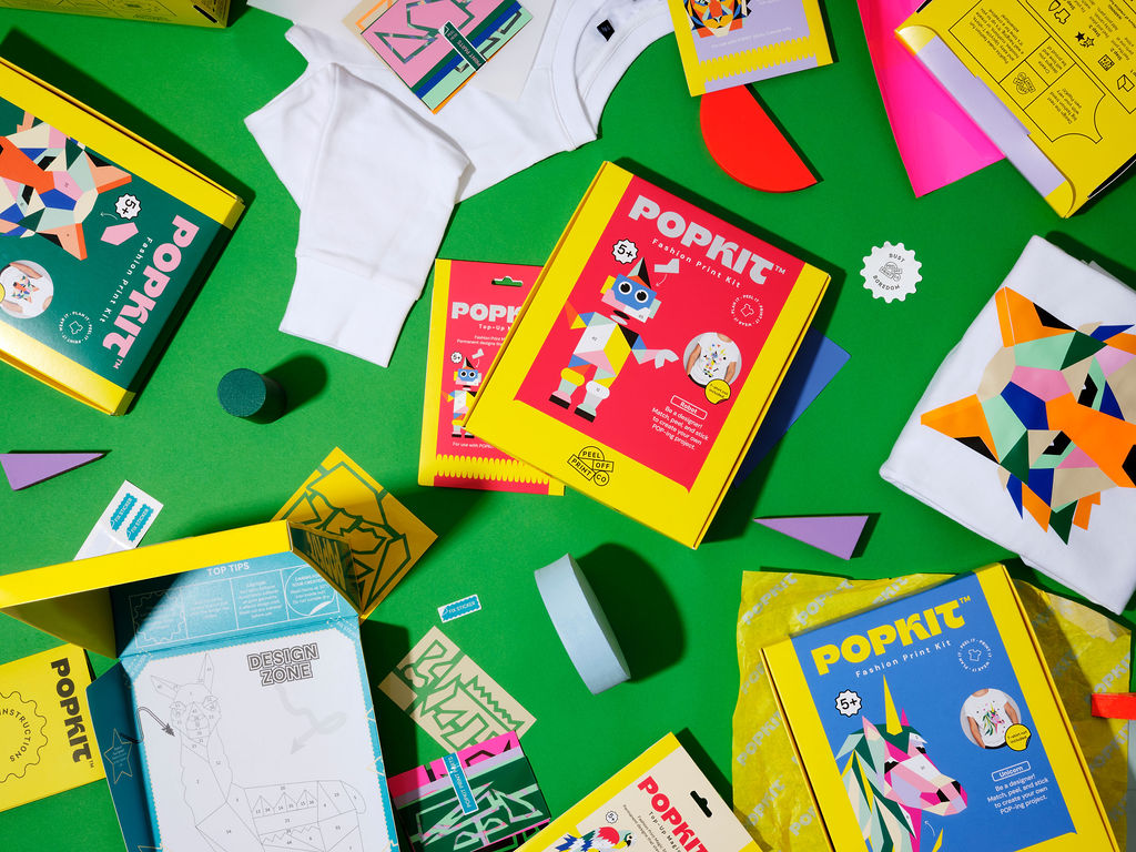 Close-up of POPKIT robot design tools, stencil, and instructions