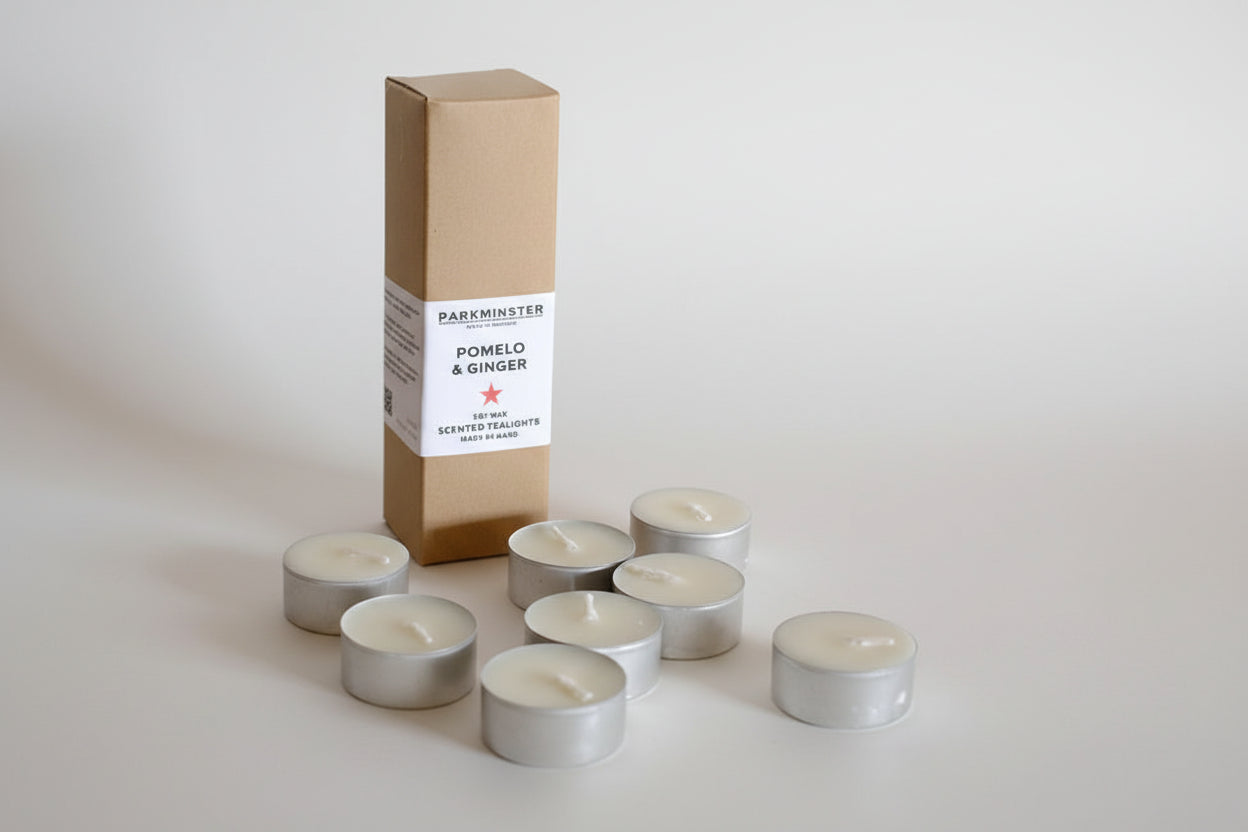 Close-up of Pomelo & Ginger soy wax tealights in recyclable aluminium cups, handmade in Cornwall
