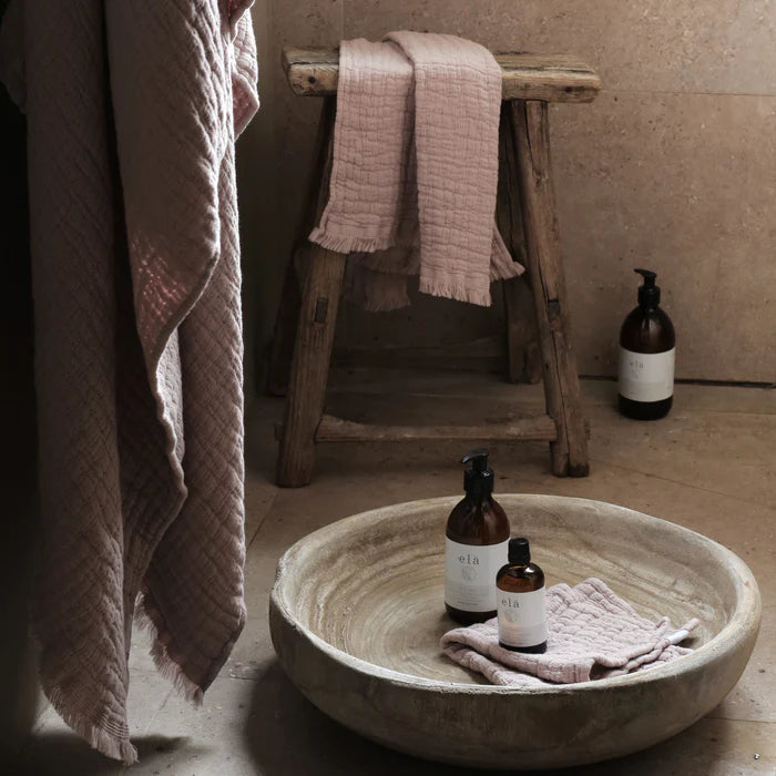 Rest No 5 Hand & Body Lotion 300ml bottle surrounded by calming botanical elements