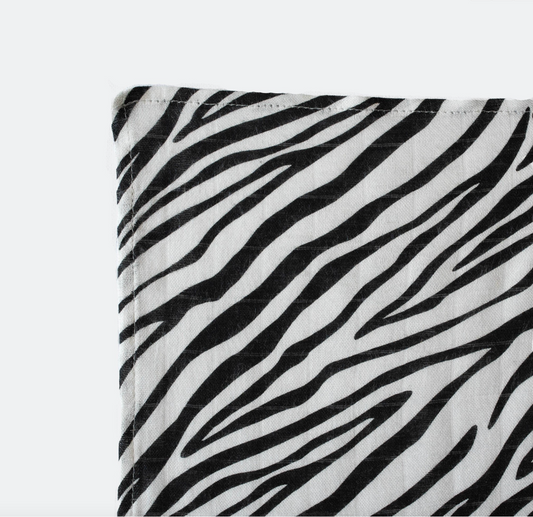 Close-up of Etta Loves Zebra comforter, soft organic cotton plush ears, stimulating baby's early vision development