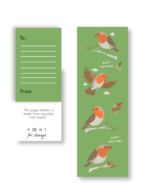 Close-up of festive green corn paper robin bookmark tucked into notebook
