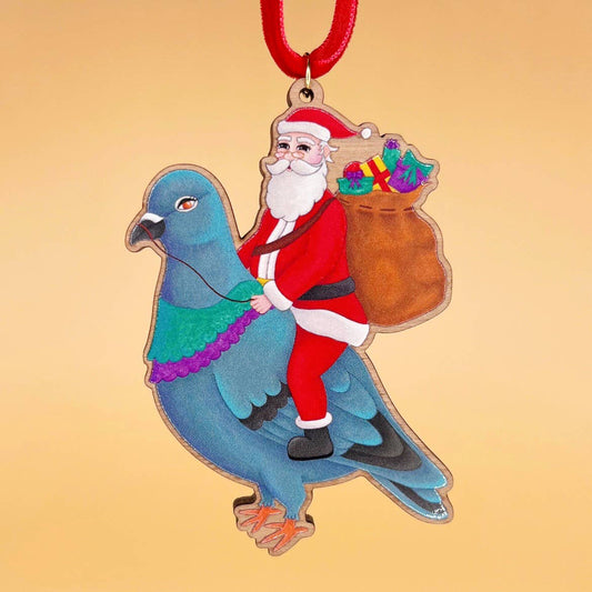 Santa Pigeon wooden Christmas tree decoration with Teddy & Kipling illustration, sustainably certified cherry wood, gold-plated ring, and red velvet ribbon