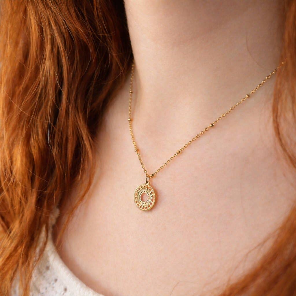 Close up of gold mandala charm and adjustable chain