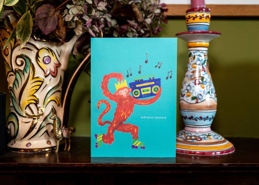 Hand-illustrated musical monkey on roller skates, “BIRTHDAY BOOGIE” text, 5x7” birthday card, UK made, with recycled kraft envelope, sustainable.