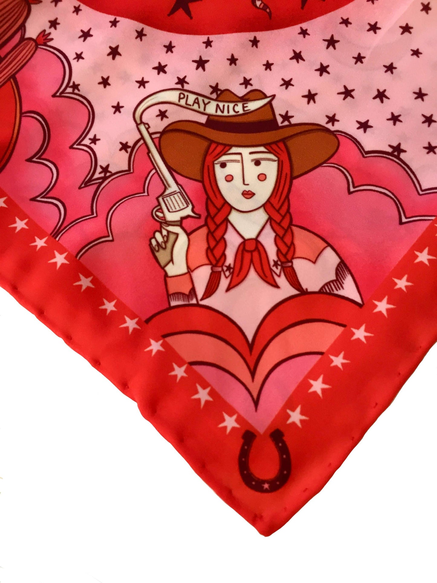 Eco silk twill pocket square with sassy cowgirl and white stallion, cacti, stars, boots, snakes, mountains, and horseshoe border in red and pink. Made from recycled polyester, designed by Su Owen.