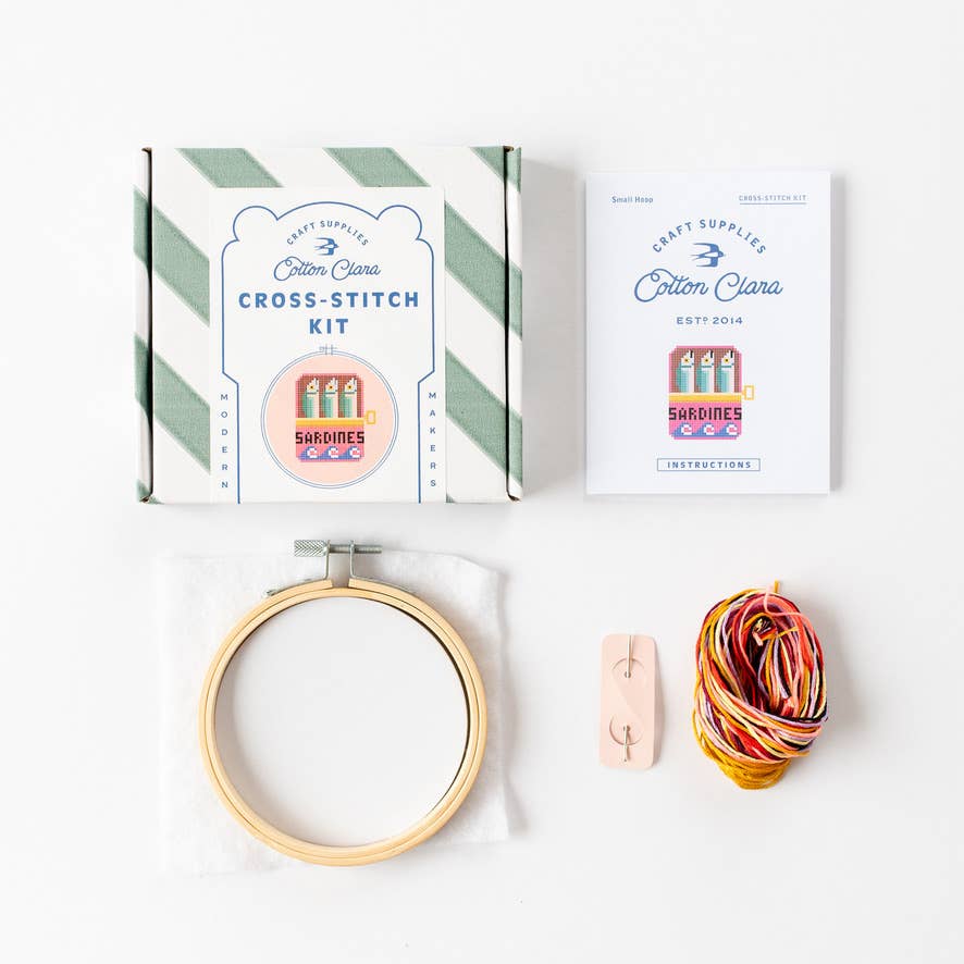 Sardines Cross Stitch Kit for beginners, featuring a 4-inch wooden hoop, coloured Aida fabric, embroidery thread, and eco-conscious packaging. Made in UK.