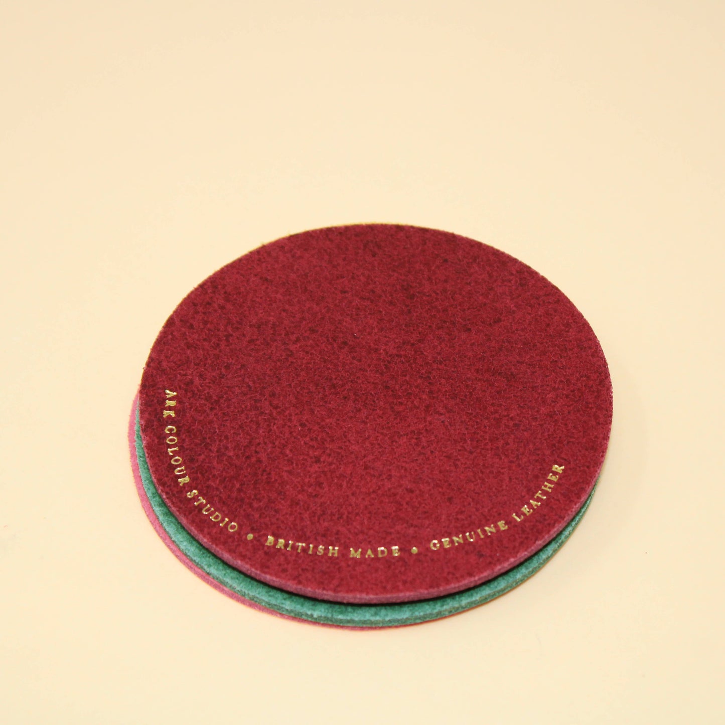 Happy Face Smilie Leather Coasters - Set of 4. Pink, Yellow, Green and Burgundy. Designed and made in the UK. Genuine Leather.