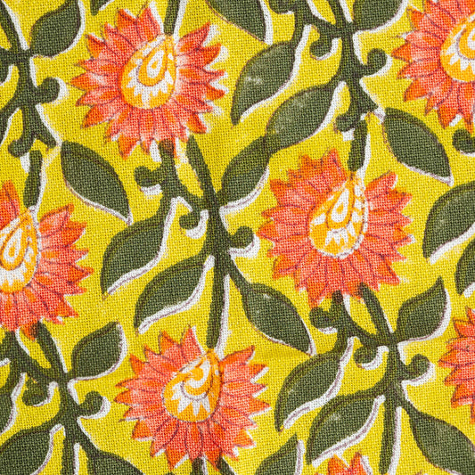 Close up of artisan block printed amber floral pattern on cotton