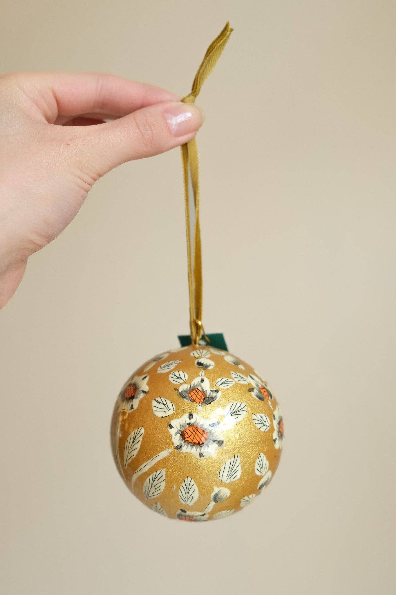 Hand-painted Gold and White Bauble by East End Press made of recycled papier mâché with velvet hanging loop